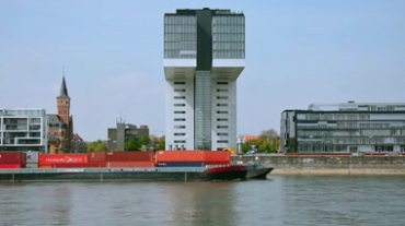 德国科隆莱茵河畔大型载货货柜轮船行驶运动镜头视频素材