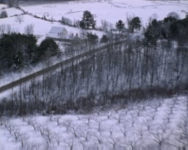 俯拍航拍冬日白雪覆盖的山体山坡农田视频素材